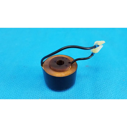 Black cylindrical solenoid actuator electromagnetic coil with copper windings and yellow wire connectors for topcon retinal camera
