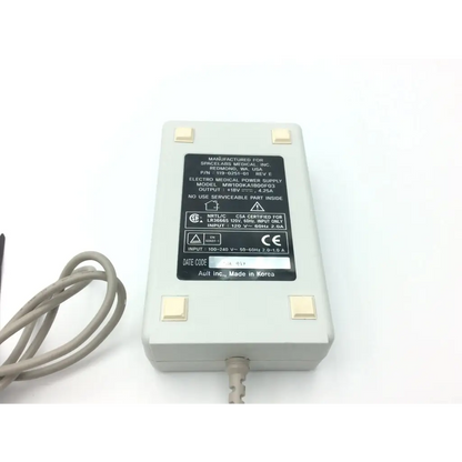 Gray plastic spacelabs rev e electro medical power supply 18v 4.25a with beige feet and coiled gray cable