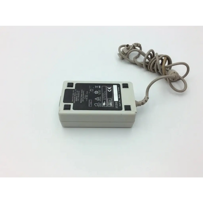 Gray rectangular spacelabs 119-0479-00 medical power supply adapter with coiled cord and certification label
