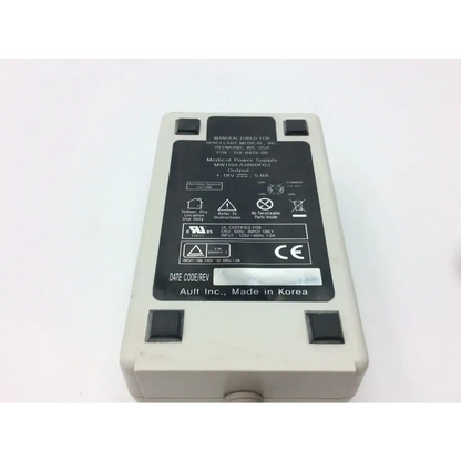Beige spacelabs 119-0479-00 medical power supply with black label and four black square buttons for medical power use