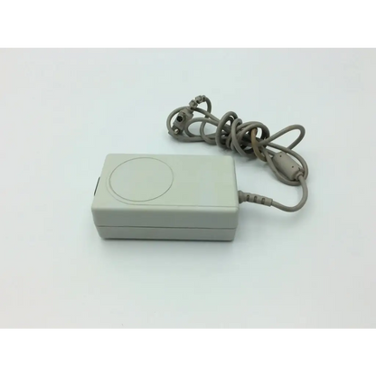 Gray rectangular spacelabs 119-0479-00 medical power supply with coiled cord and circular indentation on top for medical power use