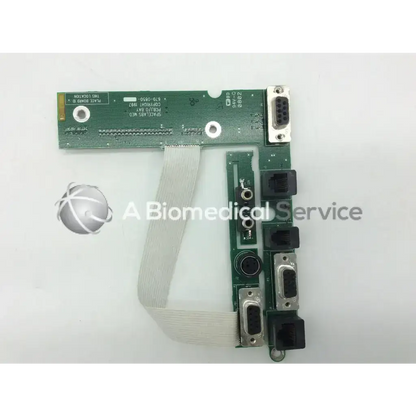 Green circuit board patient monitor data export card with multiple ports and a flexible ribbon cable for Spacelabs 650-0552-00