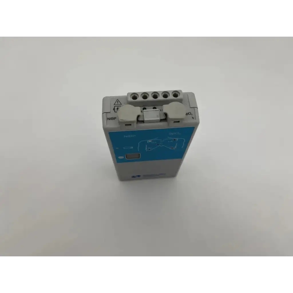 Back view of gray and blue spacelabs ultraview digital telemetry transmitter with labeled ports for nibp monitoring