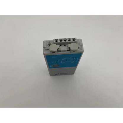 Back view of gray and blue spacelabs ultraview digital telemetry transmitter with labeled ports for nibp monitoring