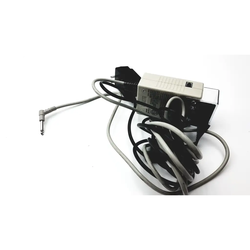 Gray and black power adapter with coiled cables and beige plastic housing featuring angled audio jack for stanley classic check 72020