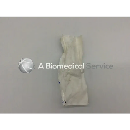 A crumpled white sterile medical glove next to sterrad chemical indicator 14100 lc-14100-004 rev for contamination detection