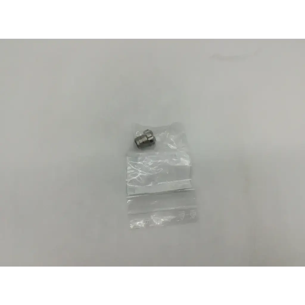 A small metallic storz 10315m glass window plug nozzle with threaded end in clear plastic packaging