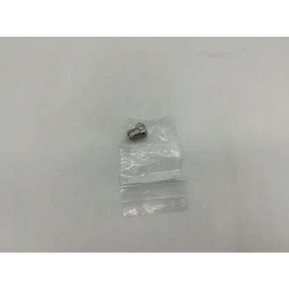 A small metallic storz 10315m glass window plug nozzle with threaded end in clear plastic packaging