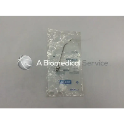 Metallic storz n7574 lock tonsil needle with curved slender shaft and small handle in clear plastic packaging