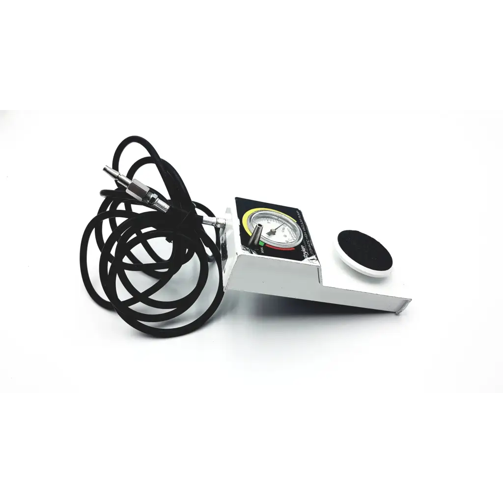 White metal automatic high vacuum foot pump with black coiled cable and circular gauge display by stryker