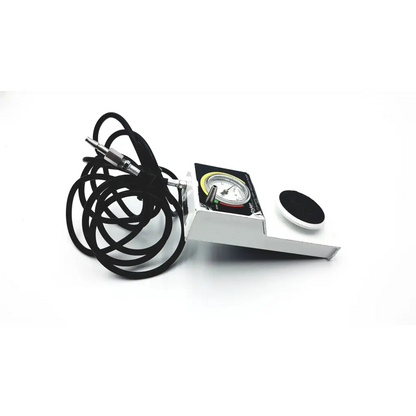White metal automatic high vacuum foot pump with black coiled cable and circular gauge display by stryker