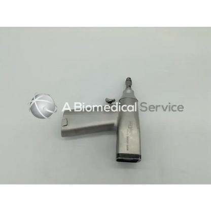Silver orthopedic surgical reciprocating drill with textured grip and black base for precise hand-held use