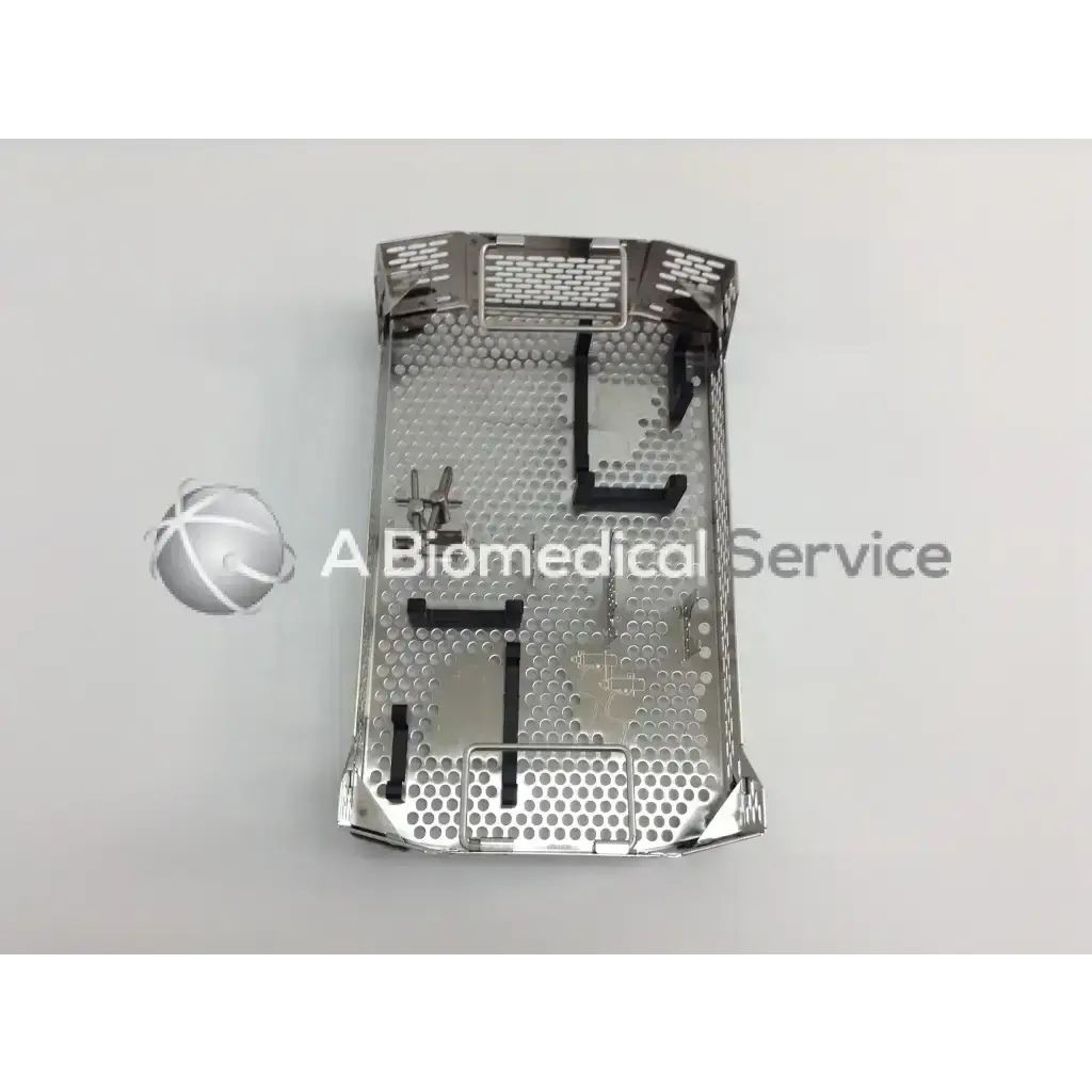 Silver metallic surgical instrument tray with perforated surface and reinforced edges in aesculap case for cordless driver set