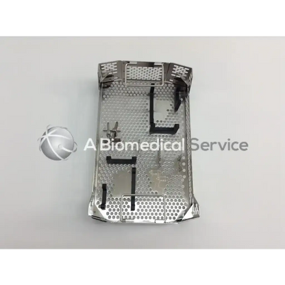 Silver metallic surgical instrument tray with perforated surface and reinforced edges in aesculap case for cordless driver set