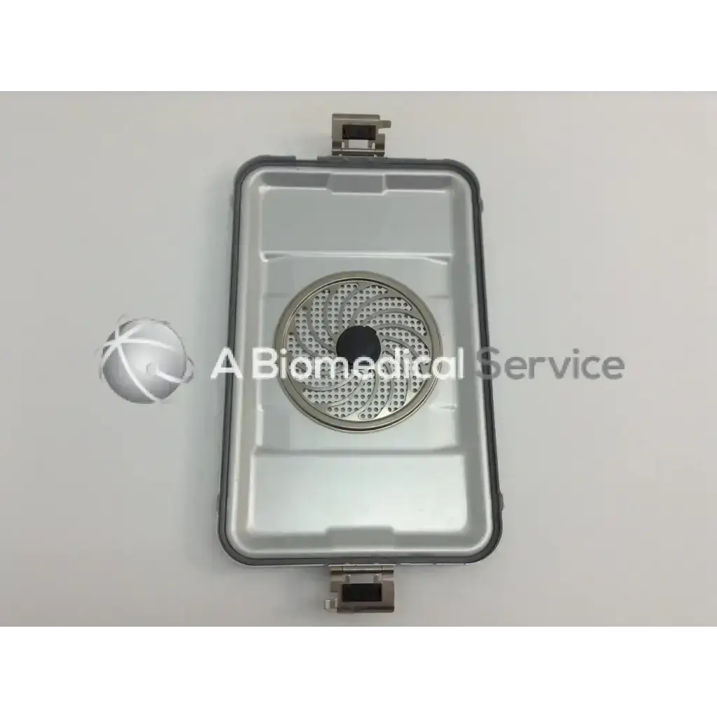 Silver metallic cordless driver set with circular perforated center and rectangular casing in aesculap case
