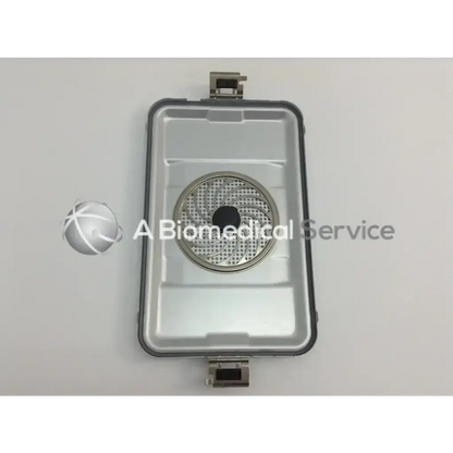 Silver metallic cordless driver set with circular perforated center and rectangular casing in aesculap case
