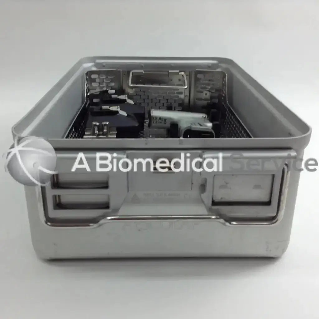 Gray stainless steel surgical instrument tray with molded handles and mesh interior for organizing tools in aesculap case