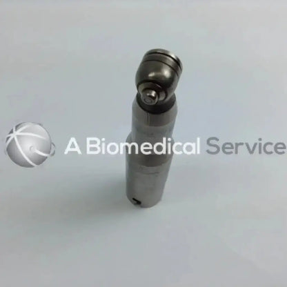 Silver metallic cordless driver handpiece with spherical head and cylindrical body in aesculap case driver set