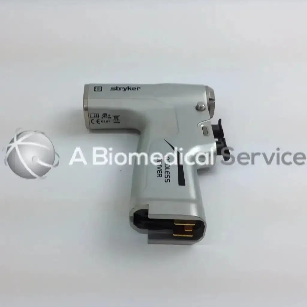 Silver stryker cordless driver with black accents and gold connector in aesculap case from driver set system 8