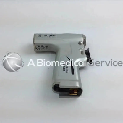Silver stryker cordless driver with black accents and gold connector in aesculap case from driver set system 8