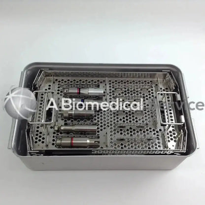 Stainless steel surgical instrument tray with perforated compartments holding medical tools for aesculap case driver set