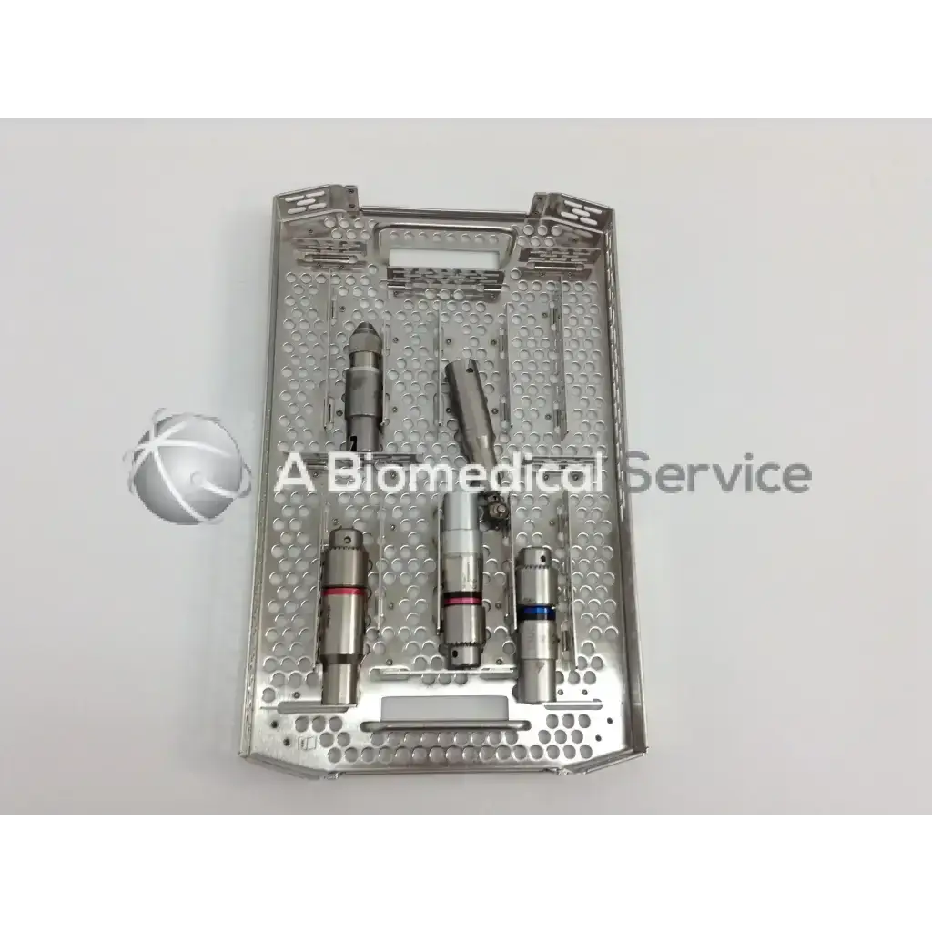 Silver perforated surgical tray with precision drills and cannulas holding stryker 4505 cordless driver set aesculap case