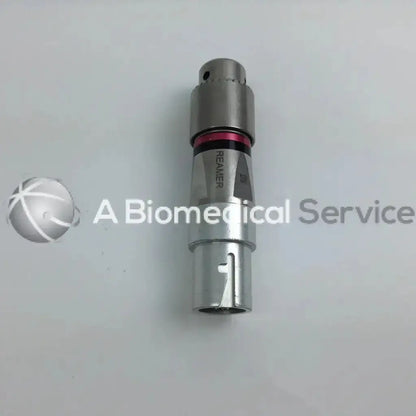 Silver metallic surgical reamer with red accent and engraved branding in stryker 4505 cordless driver set with aesculap case