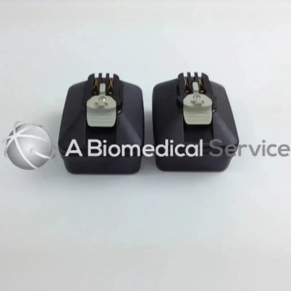 Black rectangular cordless driver set components with silver connectors and gold pins in aesculap case for stryker 4505 system