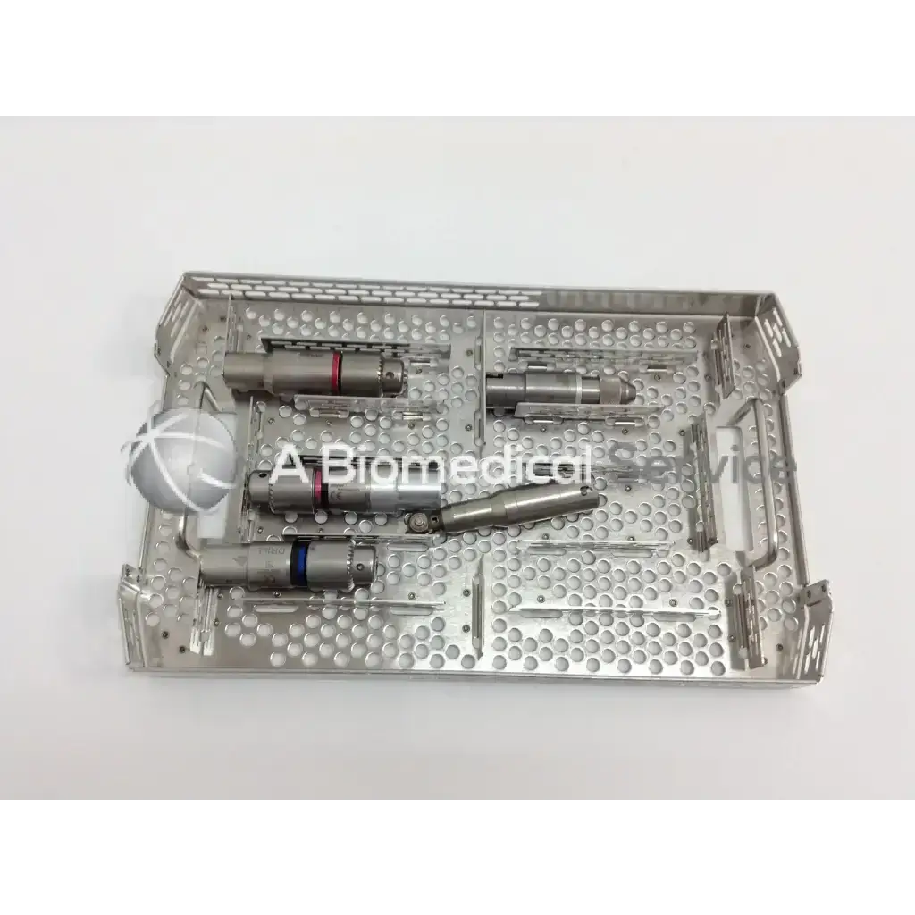 Stainless steel surgical instrument tray with perforated design and compartments holding cordless driver set in aesculap case