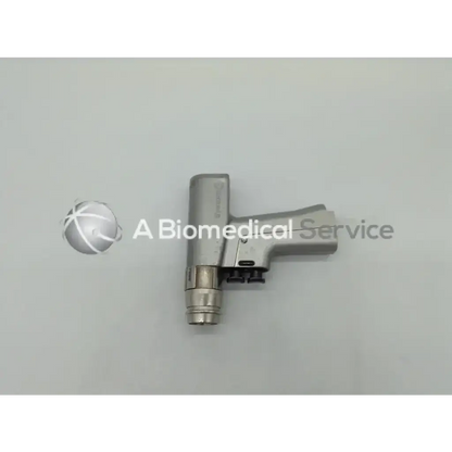 Silver stryker endoscopy dual trigger rotary drill with sleek ergonomic handle and cylindrical tip for precise surgical use