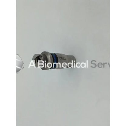 Silver-colored stryker modified trinkle drill bit with blue ring and engraved drill text for surgical use