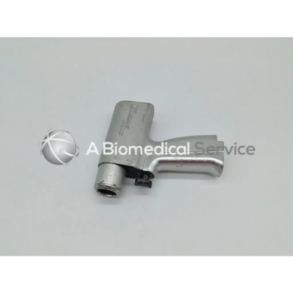 Silver metallic handle of stryker system 5 double trigger rotary drill with textured grip and engraved branding
