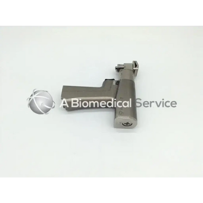 Gray metallic surgical osteotome with textured grip and ergonomic handle for stryker system 6 dual trigger rotary drill