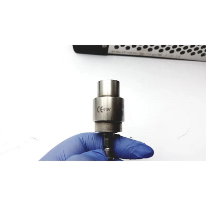 A metallic cylindrical sensor with polished stainless steel finish and engraved markings for stryker large bone battery powered drill