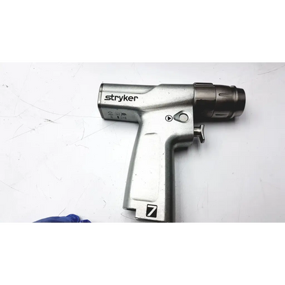 Stryker system 7 large bone battery powered drill with metallic silver body and black chuck for surgical use