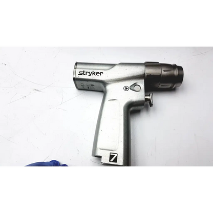 Silver stryker system 7 large bone battery powered drill with textured grip and black chuck for surgical use