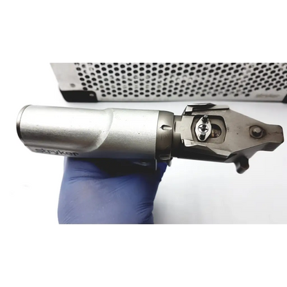 Silver stryker system 7 large bone battery powered drill with metallic ergonomic handle and precision cutting head