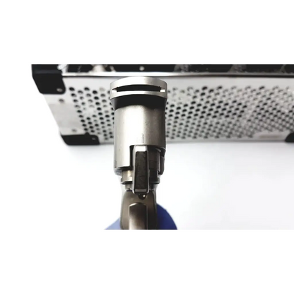 Silver metallic revolver with matte finish and black grip shown with stryker system 7 large bone battery powered drill set