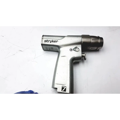 Stryker system 7 large bone battery powered drill with metallic silver body and black grip for surgical use