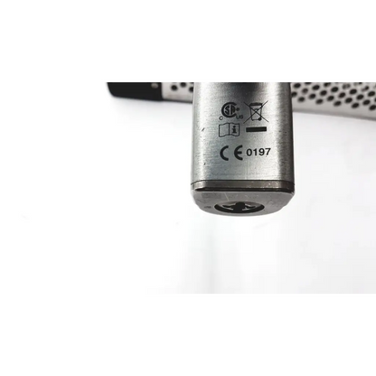 Silver metallic large bone battery powered drill cylinder with engraved certification marks and circular indentation at base