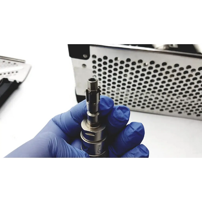 Silver surgical drill bit held in gloved hand for stryker system 7 large bone battery powered drill set 7205-000-000