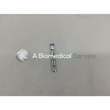 Silver metallic Synthes one-third tubular plate with collar featuring five circular holes for surgical use