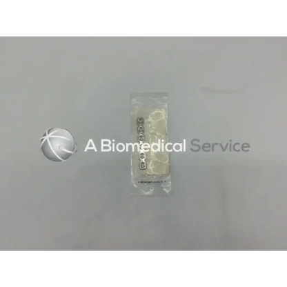 A set of five metallic circular dental implants in clear plastic packaging for 5mm reconstruction plate use