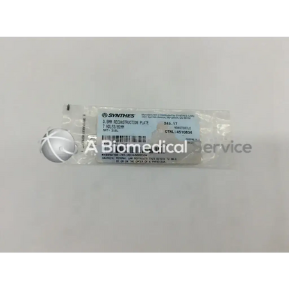Sterile metallic synthes 3.5mm reconstruction plate with seven holes in clear plastic packaging for surgical use