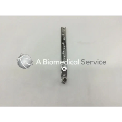 Synthes 281.90 dcs plate ad5-175 is a sleek metallic surgical plate with circular holes and a polished chrome finish