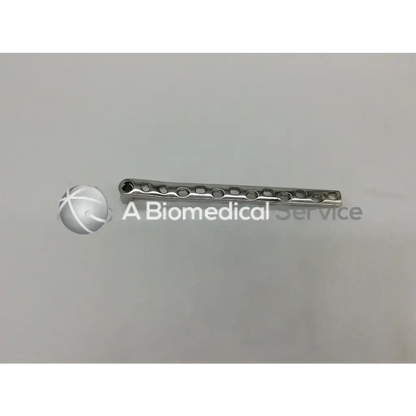 Silver metallic Synthes 281.92 dcs plate12 holes surgical plate with evenly spaced circular holes for bone fixation