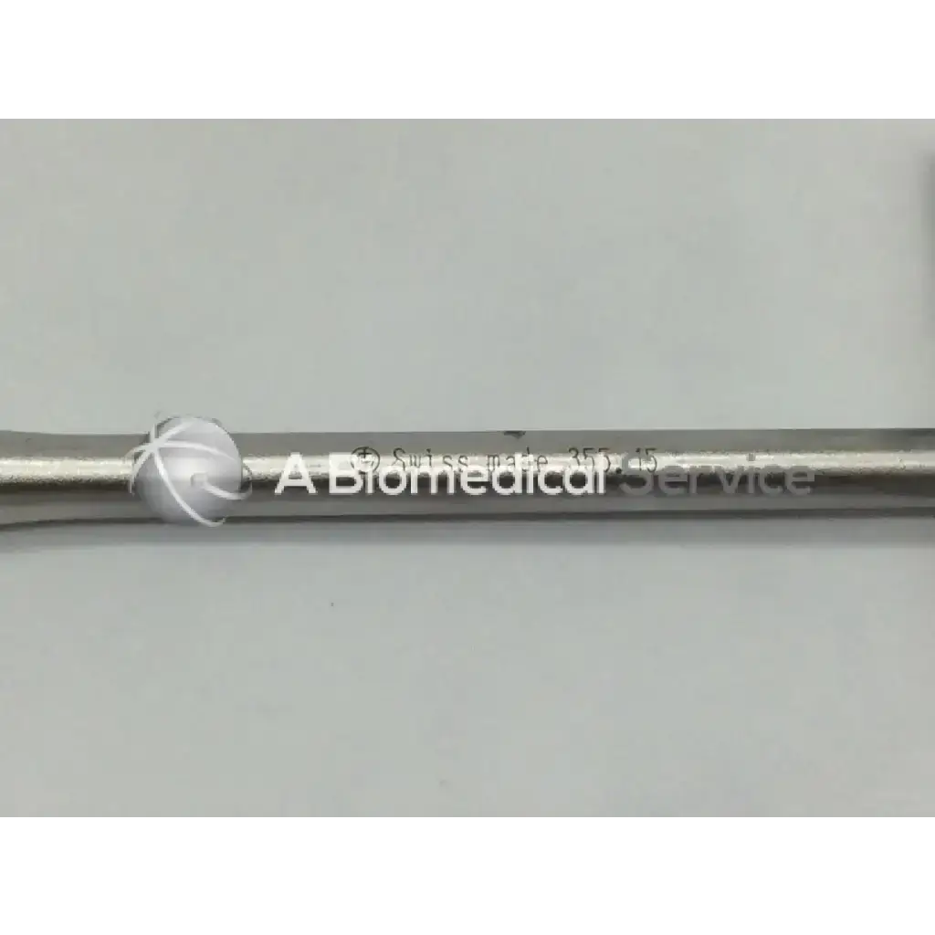 Silver metallic Synthes 355.15 cannulated socket wrench with engraved text and a spherical decorative element