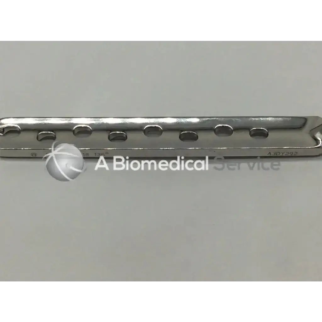 A sleek metallic synthes dhs degree plate-standard barrel with 8 evenly spaced oval holes for surgical use