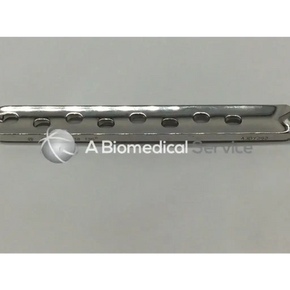 A sleek metallic synthes dhs degree plate-standard barrel with 8 evenly spaced oval holes for surgical use