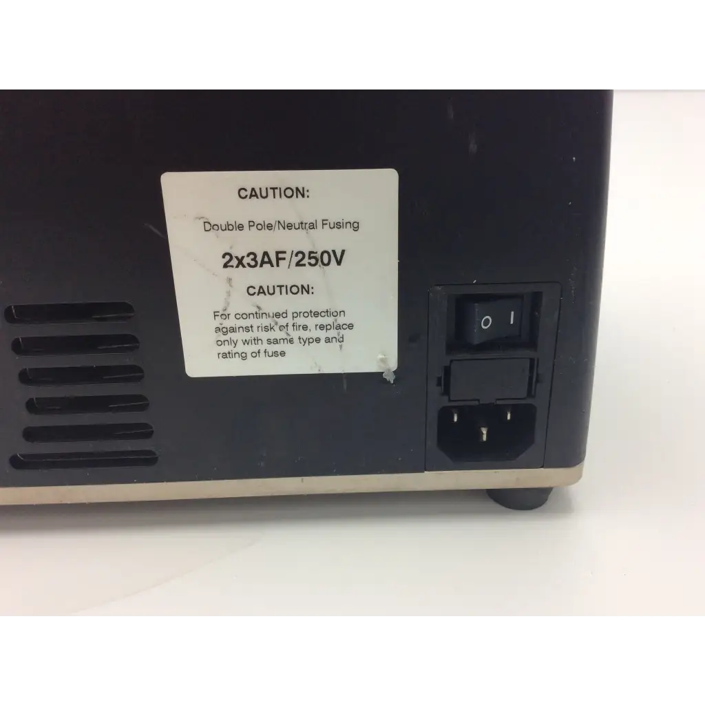 Back side of a black plastic synthes electric pen power supply with fuse label and on off switch by ac input port